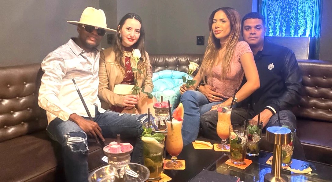 Four friends with cocktails in a lounge